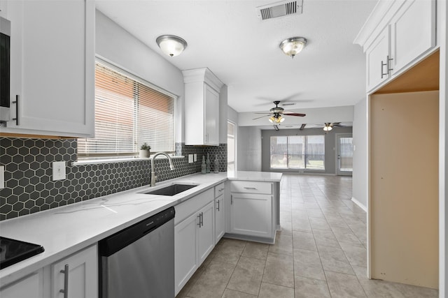 kitchen featuring light tile patterned floors, visible vents, a sink, white cabinets, and dishwasher