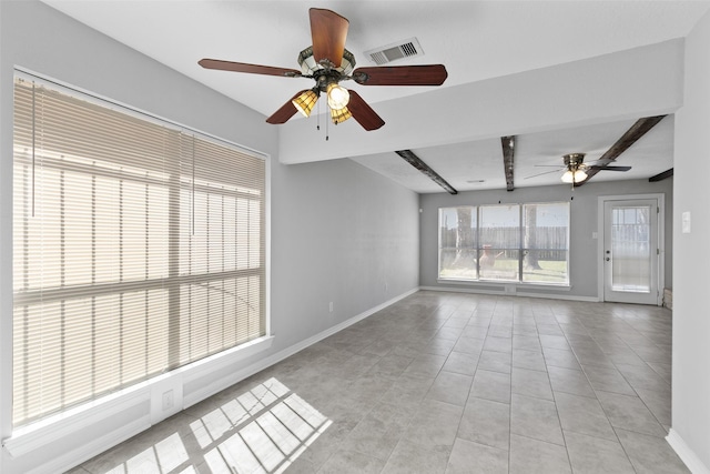 empty room with beamed ceiling, baseboards, visible vents, and light tile patterned flooring