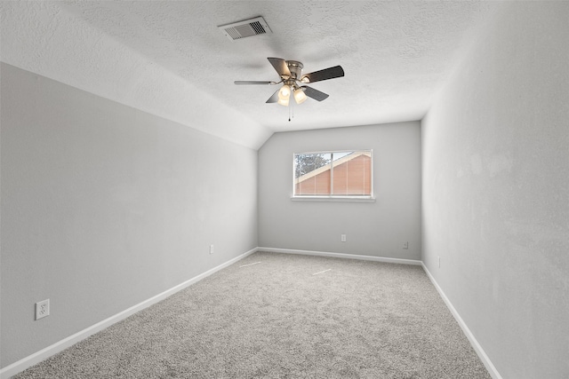 empty room with visible vents, ceiling fan, baseboards, carpet, and a textured ceiling