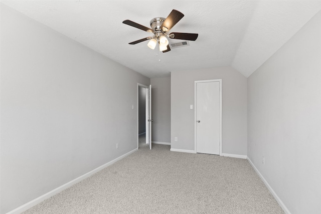 unfurnished bedroom with visible vents, a textured ceiling, baseboards, light colored carpet, and ceiling fan