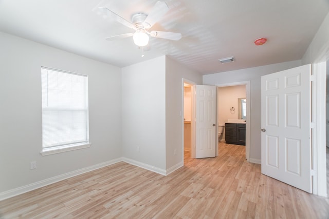 unfurnished bedroom featuring visible vents, ceiling fan, light wood-type flooring, and baseboards