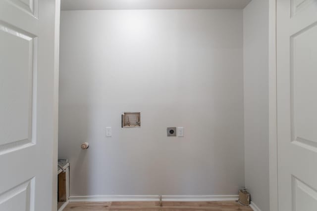 laundry area with hookup for a washing machine, baseboards, laundry area, electric dryer hookup, and light wood-style floors