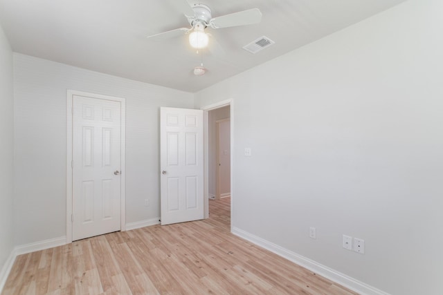 unfurnished bedroom with visible vents, ceiling fan, light wood-type flooring, and baseboards