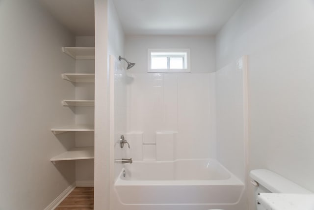 full bathroom featuring toilet, shower / bathing tub combination, baseboards, and wood finished floors