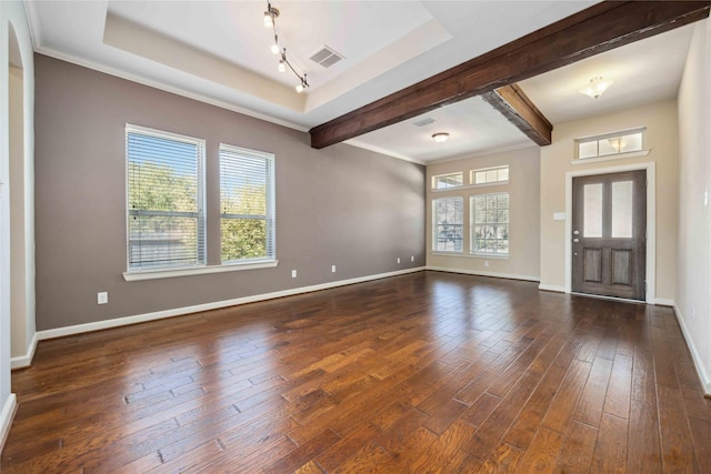 entrance foyer featuring a wealth of natural light, visible vents, baseboards, and wood finished floors