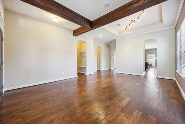 unfurnished living room with visible vents, beam ceiling, dark wood finished floors, arched walkways, and baseboards