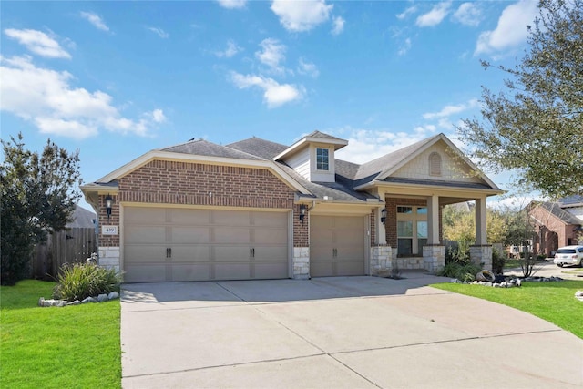 view of front facade featuring brick siding, an attached garage, a front yard, and fence