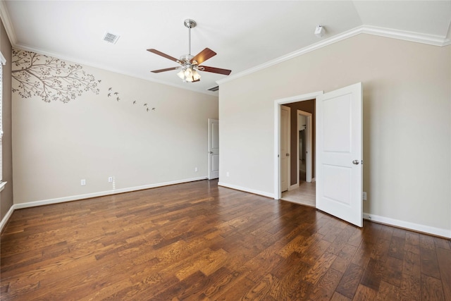 unfurnished room with visible vents, hardwood / wood-style floors, vaulted ceiling, and ornamental molding