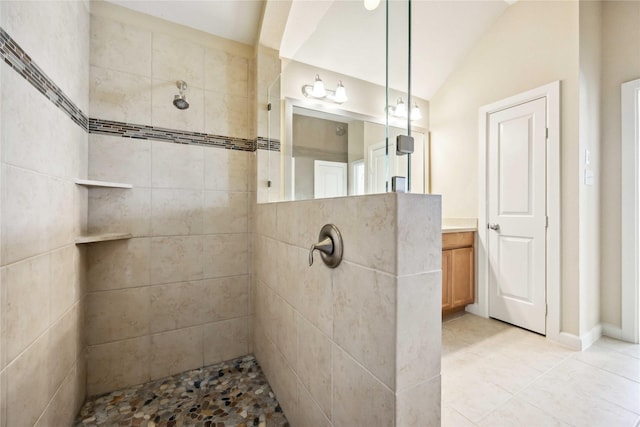 full bathroom with tile patterned floors, vanity, walk in shower, and vaulted ceiling