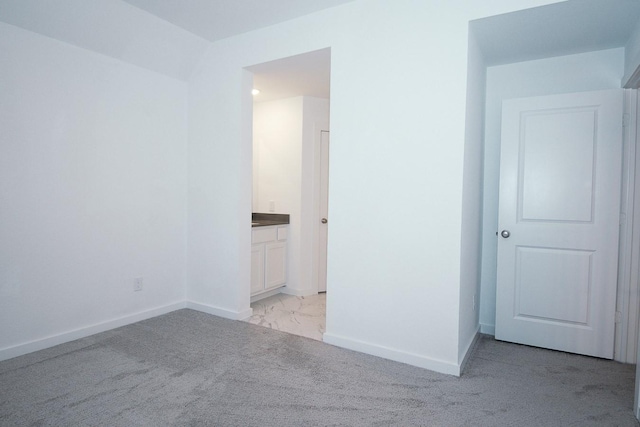 9647 Wright Dr, Manvel, TX 77578 - unfurnished bedroom featuring light marble finish flooring, ensuite bath, and light colored carpet