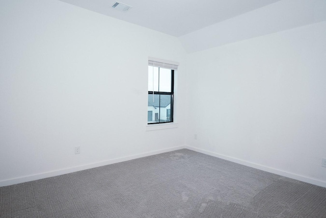 9647 Wright Dr, Manvel, TX 77578 - empty room featuring dark colored carpet and vaulted ceiling