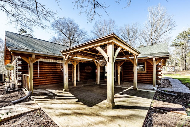 view of patio / terrace with a gazebo, cooling unit, a carport, and concrete driveway