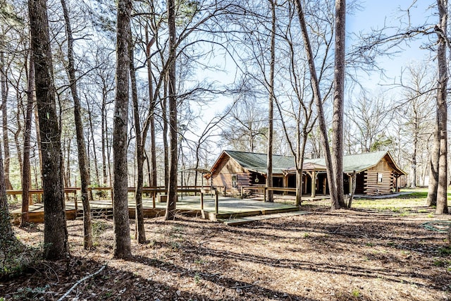 rear view of house featuring log siding