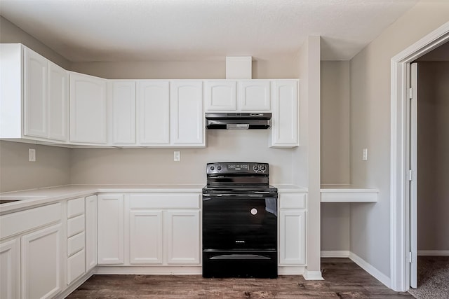 kitchen with under cabinet range hood, dark wood-style floors, black / electric stove, and white cabinets