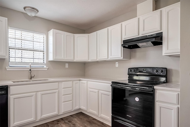 kitchen featuring dark wood-type flooring, black appliances, under cabinet range hood, a sink, and white cabinets