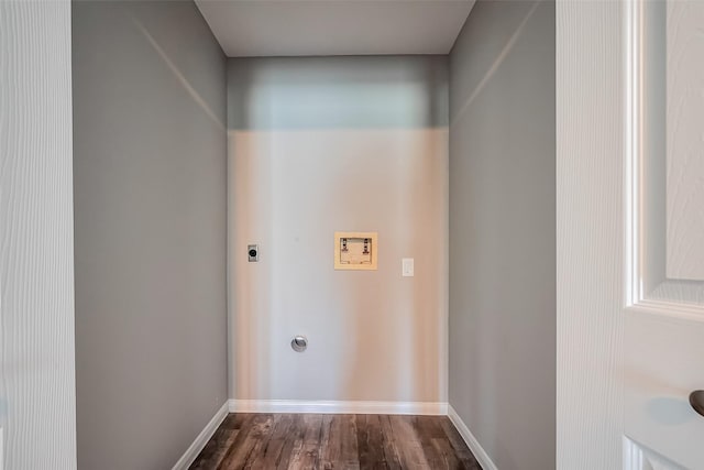 washroom with dark wood finished floors, baseboards, hookup for an electric dryer, hookup for a washing machine, and laundry area