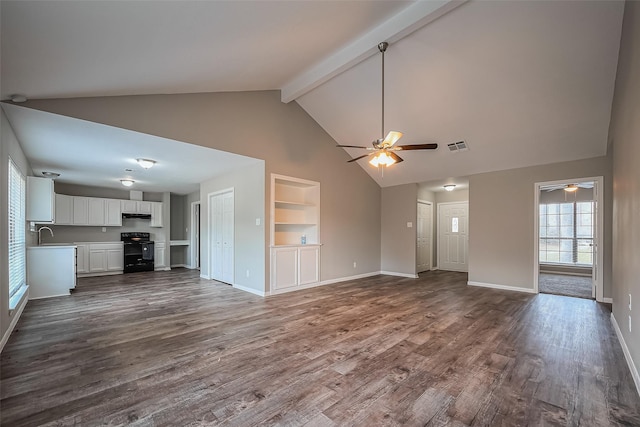 unfurnished living room with beam ceiling, built in features, dark wood-type flooring, and baseboards