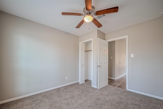 unfurnished bedroom with visible vents, a ceiling fan, a closet, baseboards, and light colored carpet