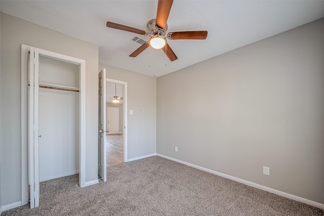 unfurnished bedroom featuring a ceiling fan, visible vents, baseboards, carpet floors, and a closet