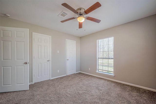 unfurnished bedroom with visible vents, ceiling fan, baseboards, and carpet floors