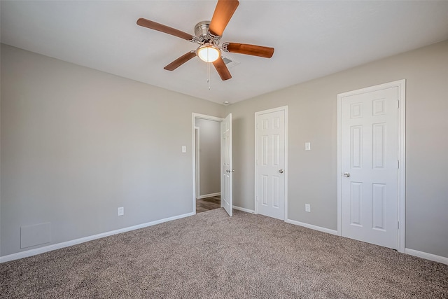 unfurnished bedroom featuring visible vents, baseboards, a ceiling fan, and carpet flooring