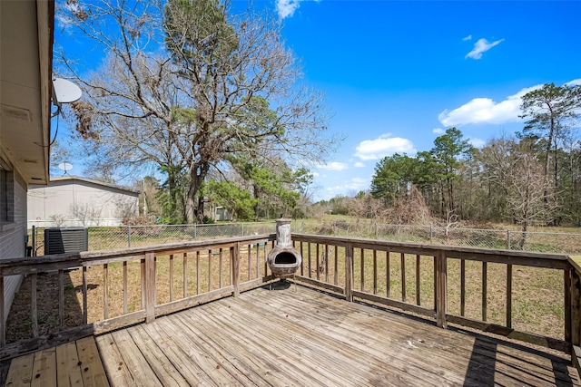 deck featuring cooling unit and fence