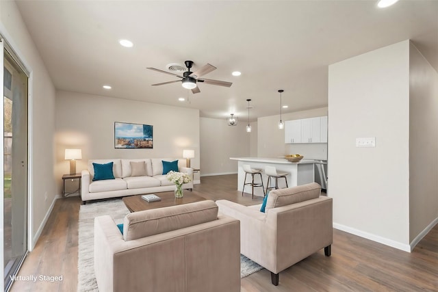 living area with recessed lighting, baseboards, light wood finished floors, and ceiling fan