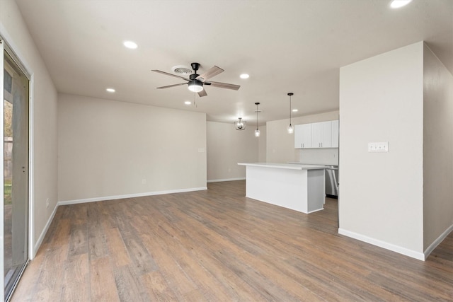 unfurnished living room featuring recessed lighting, baseboards, a ceiling fan, and wood finished floors