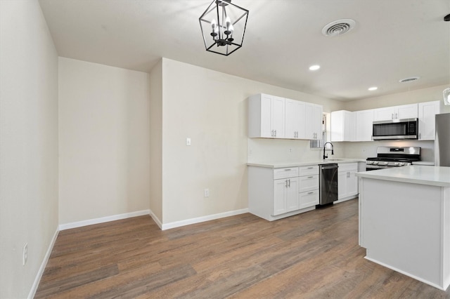 kitchen with visible vents, dark wood finished floors, light countertops, appliances with stainless steel finishes, and white cabinets