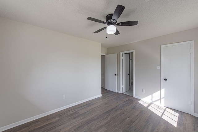 unfurnished bedroom with ensuite bathroom, a ceiling fan, a textured ceiling, wood finished floors, and baseboards