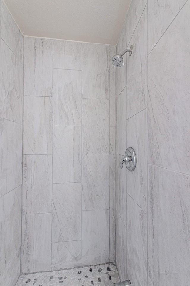 bathroom with tiled shower