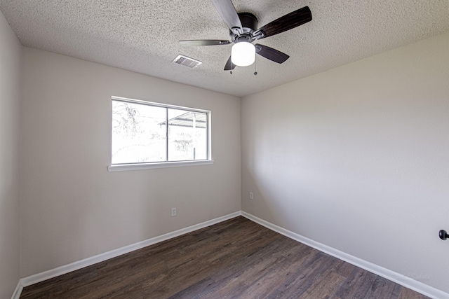 unfurnished room featuring visible vents, a textured ceiling, dark wood-style floors, baseboards, and ceiling fan