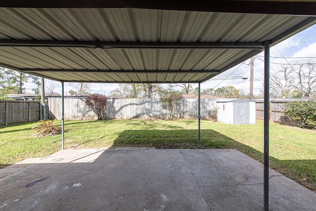 view of patio featuring a storage unit, a fenced backyard, and an outdoor structure