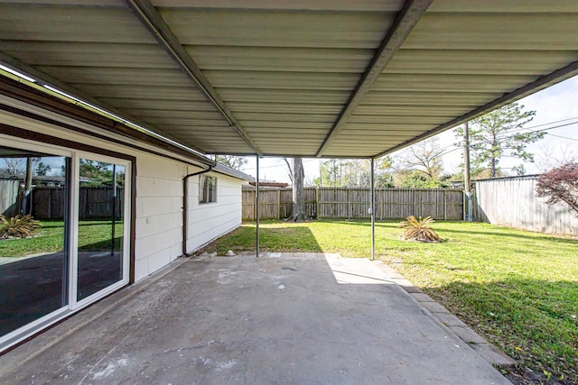 view of patio featuring a carport and a fenced backyard