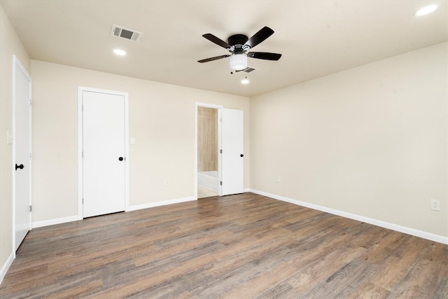 unfurnished bedroom with visible vents, recessed lighting, baseboards, and wood finished floors