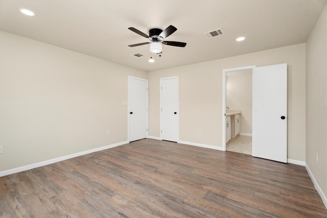 unfurnished bedroom featuring visible vents, recessed lighting, baseboards, and wood finished floors