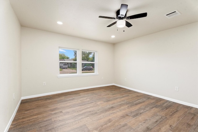 unfurnished room with recessed lighting, wood finished floors, visible vents, and baseboards