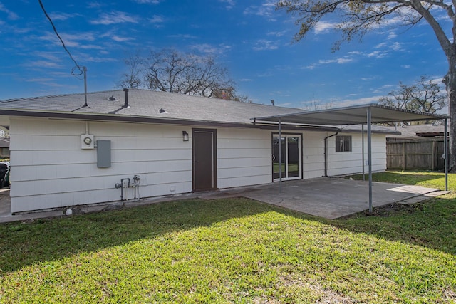 back of property featuring a yard, a patio area, and fence