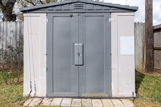 view of shed with fence