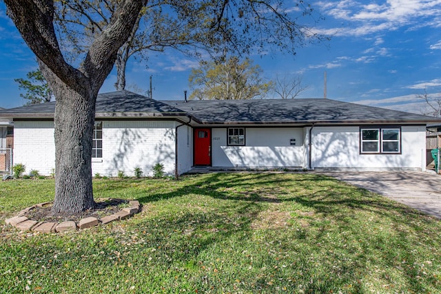 ranch-style house with a front lawn, concrete driveway, and brick siding