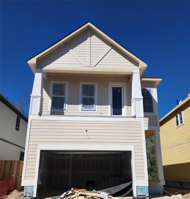 view of front facade with an attached garage and fence