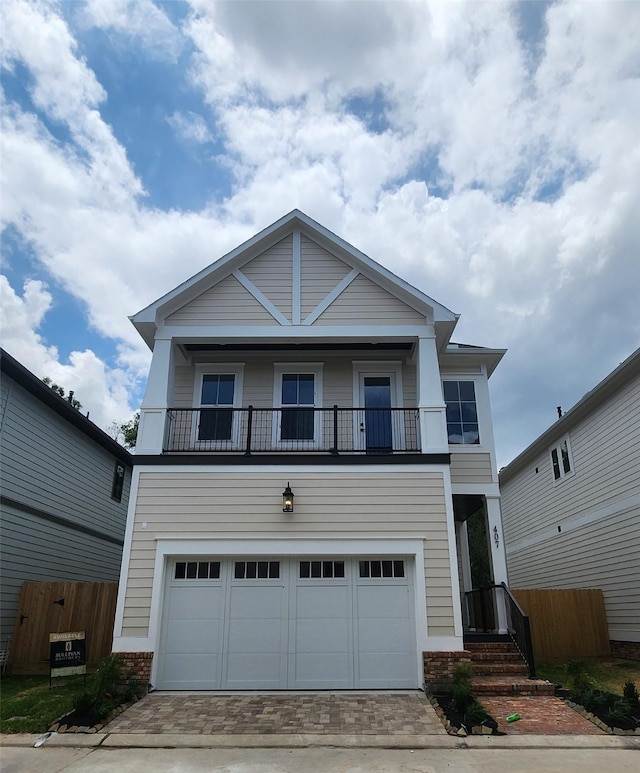 407 Forest Reserve Pl, Houston, TX 77079 - view of front facade featuring a balcony, a garage, brick siding, and driveway