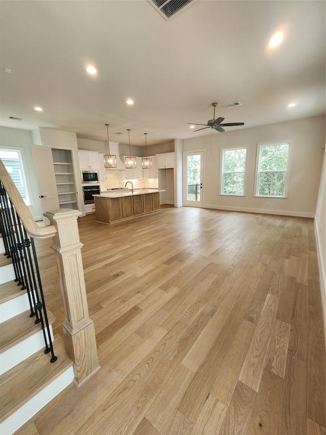 407 Forest Reserve Pl, Houston, TX 77079 - living area featuring recessed lighting, light wood-type flooring, baseboards, a ceiling fan, and stairway