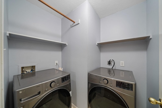 laundry area with laundry area, a textured ceiling, and separate washer and dryer