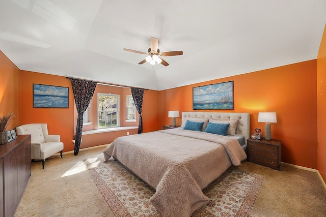 bedroom featuring baseboards, lofted ceiling, and light colored carpet