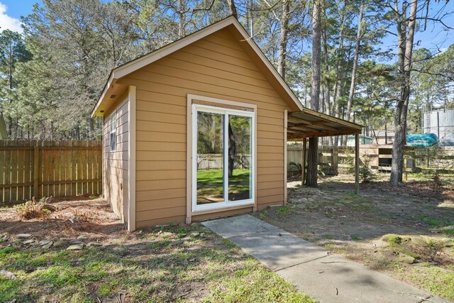 view of outdoor structure with an outbuilding and fence