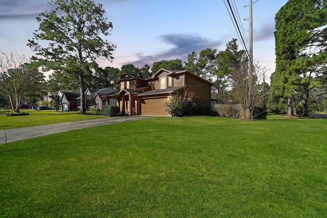 view of front of property with concrete driveway and a front yard