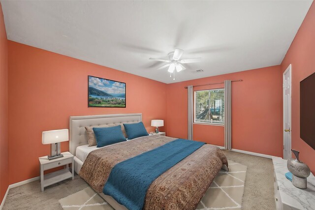 carpeted bedroom featuring a ceiling fan, visible vents, and baseboards