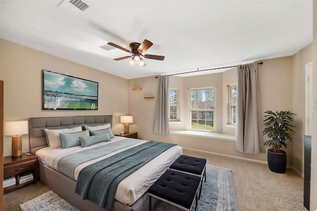 carpeted bedroom with baseboards, visible vents, and ceiling fan