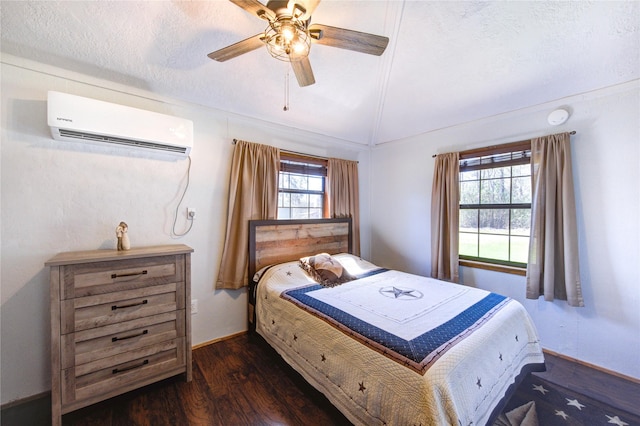 bedroom with a wall mounted AC, a textured ceiling, lofted ceiling, ceiling fan, and dark wood-style flooring